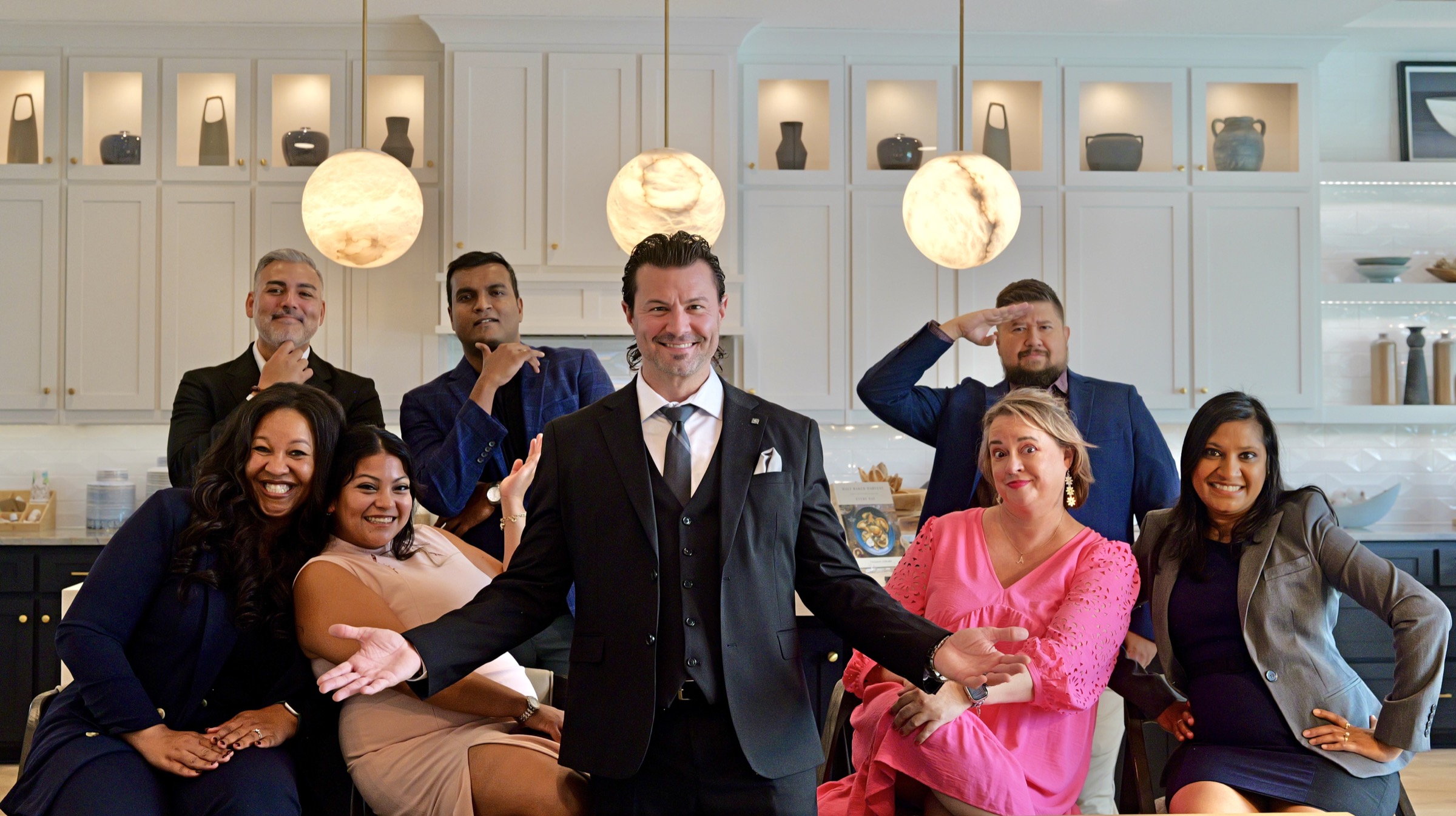 Members of The Top Gun Team together in a bright kitchen